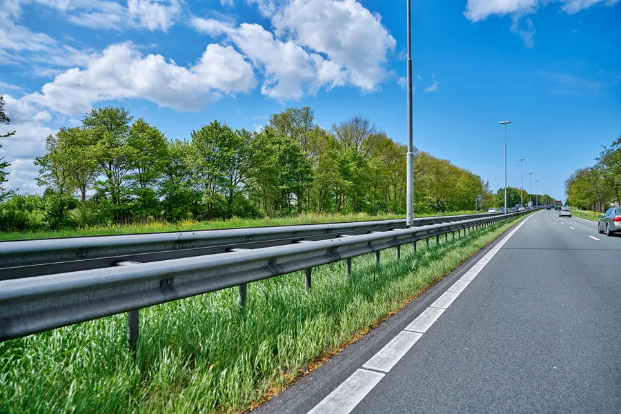 Highway lighting poles with ground screw foundations